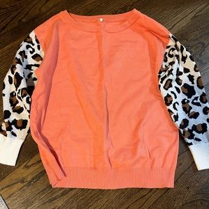 Coral sweater with leopard sleeves